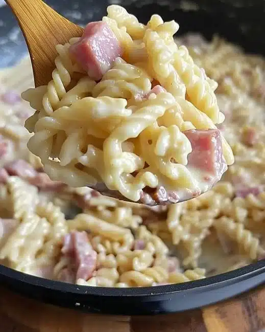 Creamy Ham and Comté Pasta served in a bowl with herbs.