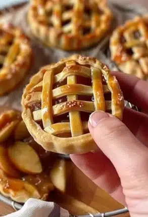 Mini tartes aux pommes prêtes à être dégustées, délicieusement garnies de pommes sucrées.